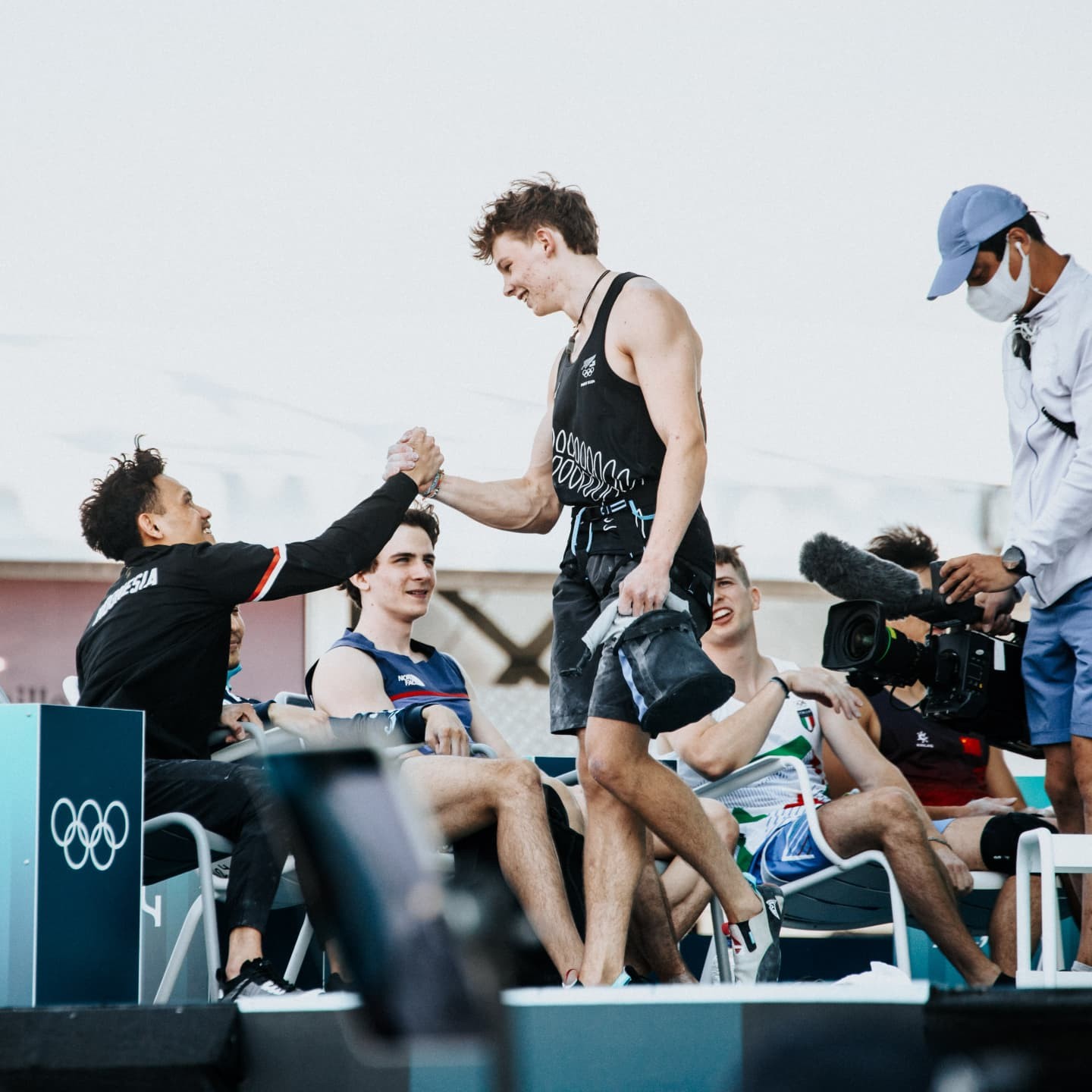 Julian David at the Paris 2024 Olympic Games, congratulated by fellow speed climbers at Le Bourget